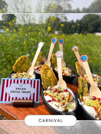 Our popular Palak Patta Chaat gets a carnival twist with playful toppers. We served this dish in an outdoor setting against a beautiful field of yellow flowers.
