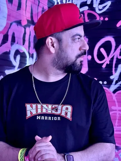 A portrait against the pink graffiti wall, soaking in the hip hop culture.