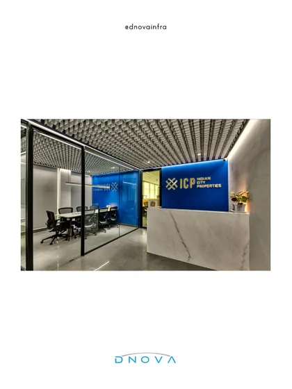 The reception area for Indian City Properties features a bold blue brand wall and a sleek marble desk. My team executed this design, which uses glass partitions to promote a culture of transparency.