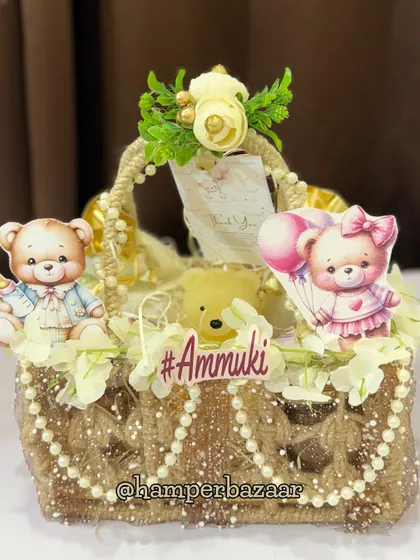 A rustic and charming jute hamper for baby Ammuki, decorated with teddy bears, pearls, and flowers.