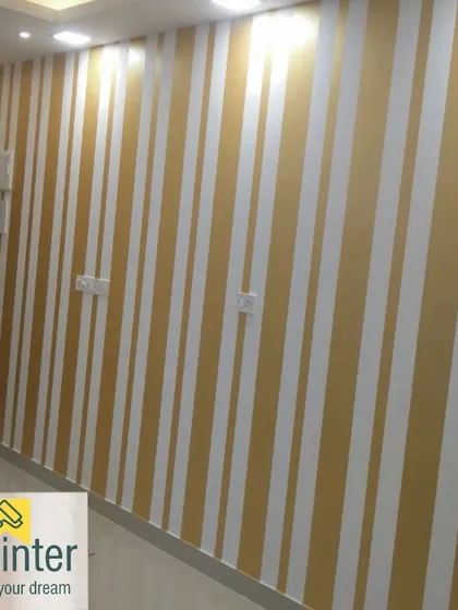 Another view of the gold and white striped wall, showcasing the clean execution and the reflective quality of the metallic gold paint.