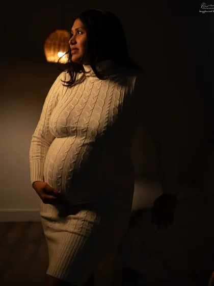 Using warm, low light to create a cozy and intimate mood. The cable-knit dress adds texture to this beautiful low-key portrait.