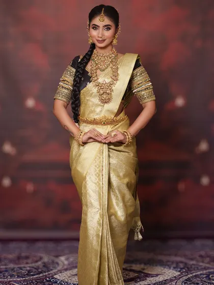 A graceful and poised full-length shot. This golden saree is incredibly versatile and can be styled in many ways for different wedding events.