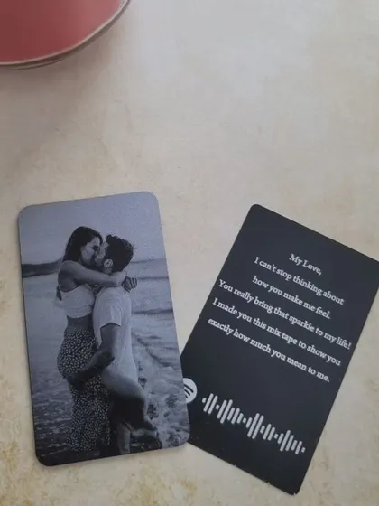 Duplicate of 36. A romantic wallet card featuring a couple's photo on one side and a personal message with a scannable Spotify song code on the other.