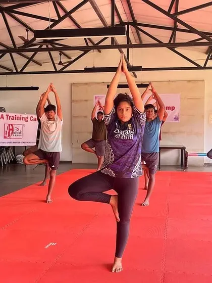 A warrior's strength comes from balance. We incorporate yoga into our camps to improve flexibility, focus, and recovery. Here, our students practice the Tree Pose (Vrikshasana) to build stability and mental calm.