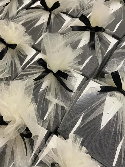 The final presentation of our 'Suit Up' groomsmen hampers. Each box is wrapped in delicate white tulle with a black ribbon, resembling a tuxedo and adding a touch of class.