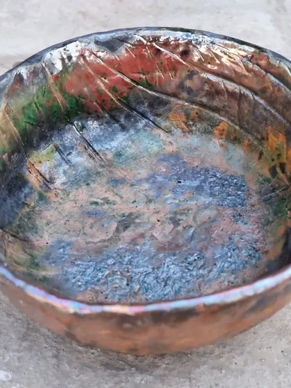 A Raku-fired bowl from one of my workshops. The participant's carved textures are highlighted by the metallic and crackled glaze effects, creating a piece that is truly unique.