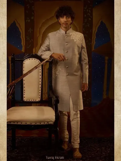The portrait of Yuvraj Vikram. His modern-cut sherwani with subtle embroidery was chosen to position him as the younger, perhaps more progressive, heir in the 'Ek Mahal Ki Daastan' narrative.