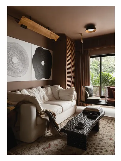 This lounge space in our own home features a plush, slip-covered white sofa. It’s a comfortable, inviting piece that anchors the room, proving that even in a compact 850 sq ft apartment, you can create a cozy and stylish world.