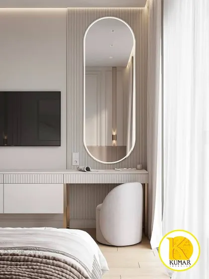 A view of the dressing table in the white bedroom, featuring a large, backlit oval mirror.