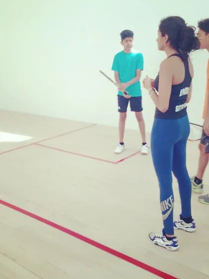 Coach Shruti Settipalli discusses strategy with two of our intermediate players. These on-court conversations help build game intelligence and decision-making skills.