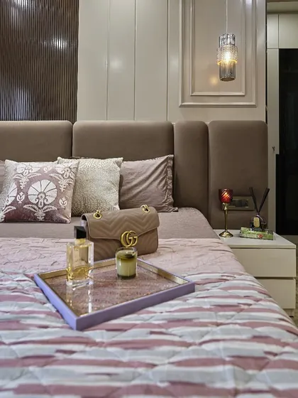 A close-up of the bed styling. Layering different textures with pillows and a quilted bedspread is a simple hack to make your bedroom feel more luxurious.