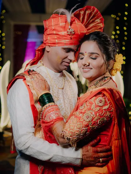 Another angle of a tender embrace, focusing on the bride's expression and the beautiful embroidery on her blouse.