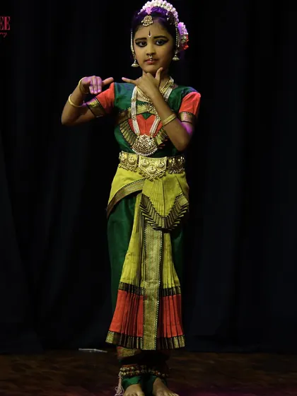 A young student from our Bharatanatyam batch, showcasing the grace and poise she has learned in class during her stage performance.