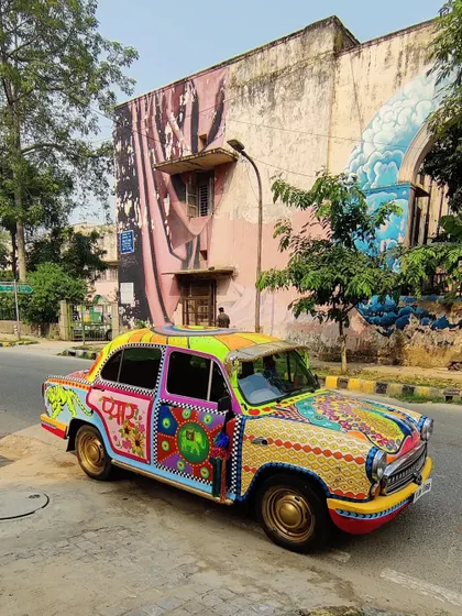 Art doesn't have to be confined to walls. This vintage Ambassador car was transformed into a vibrant canvas, fusing Indian truck art aesthetics with kitsch and maximalist design for a truly one-of-a-kind mobile masterpiece.