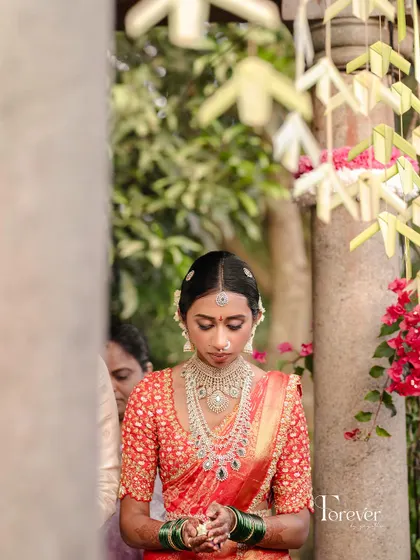 A quiet moment of reflection for the bride during her wedding ceremony. Her minimalist makeup look is perfect for the solemnity of the rituals.