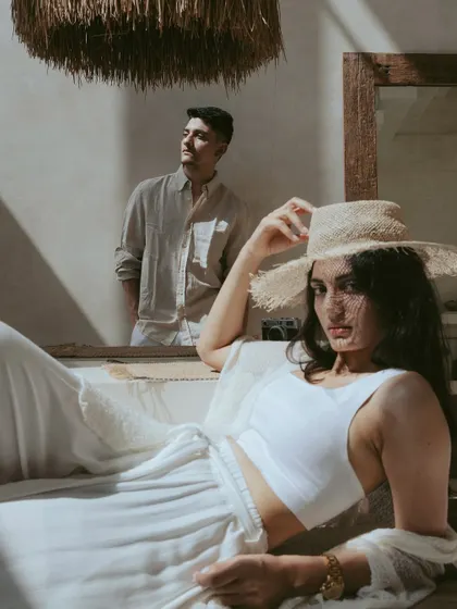 A beautifully layered portrait with her in the foreground and him reflected in the mirror behind her. This artistic shot from their Bali pre-wedding session explores themes of perspective and togetherness in a creative way.