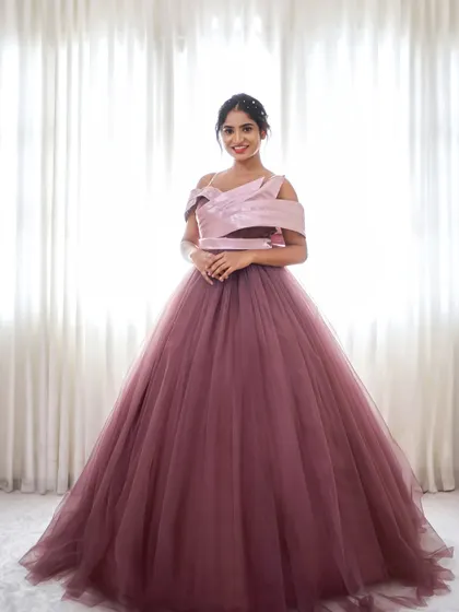 Feel like royalty in our Royalty gown. This dusty rose ballgown features a full tulle skirt and a modern, structured bodice.