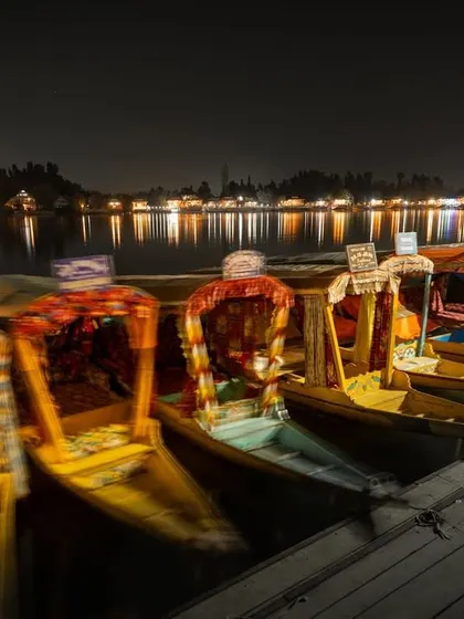 The houseboats of Srinagar by night. The long exposure captures the stillness of the water and the warm glow of the lights, creating a completely different mood from the daytime.