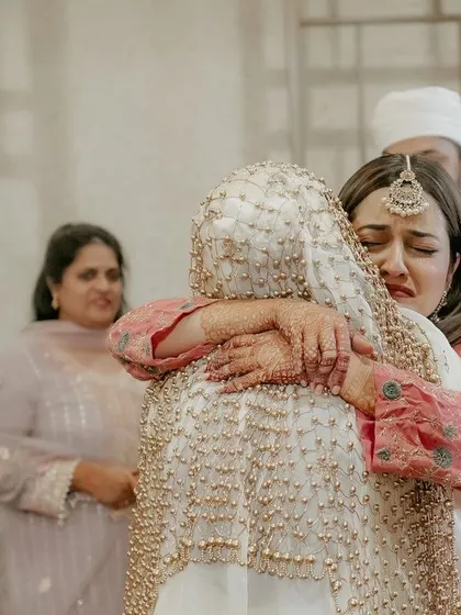 A powerful, emotional hug between the bride and a loved one, capturing the raw emotion of the day.