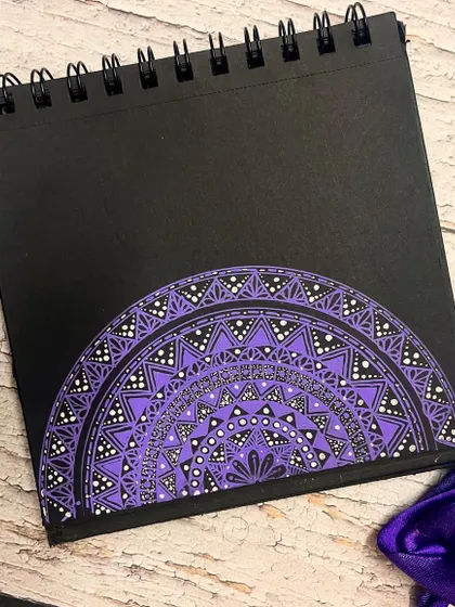 Another view of the purple Navratri mandala on a rustic wooden background.