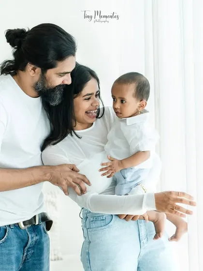 Using the soft, natural light from the studio window, I captured this family sharing a smile. This technique creates a bright and airy feel, highlighting their happy interaction.