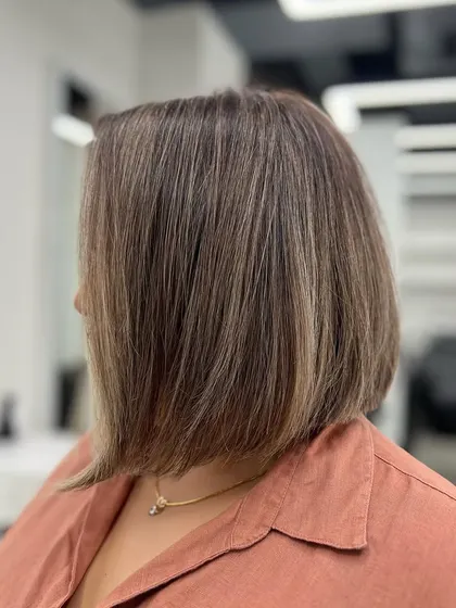 Another angle of the ash blonde bob, showing the beautiful dimension and healthy shine of the hair.