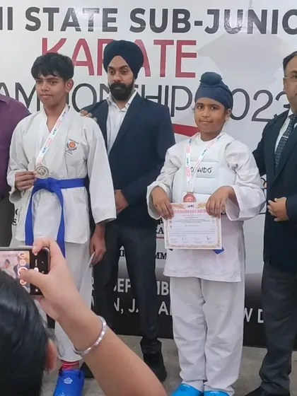 Two of my students on the podium after a tough competition. This moment captures the spirit of sportsmanship and respect for one's opponent, which are core tenets of karate.