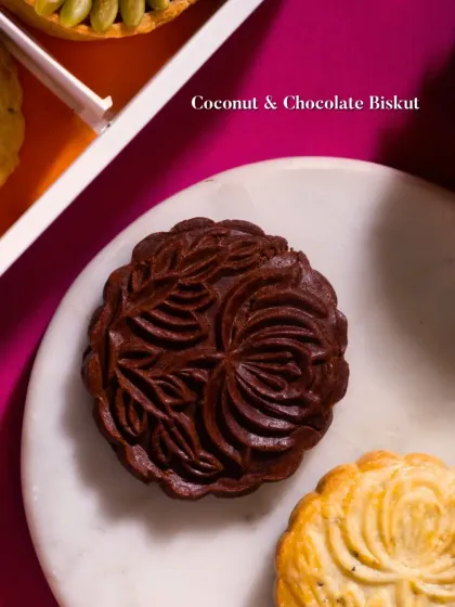 A Coconut & Chocolate Biskut, intricately molded and deeply flavorful. A perfect sweet ending for a festive meal.