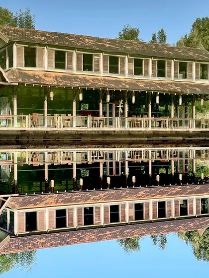 The calm morning light on the ODEA' restaurant. The use of wooden shutters and an extended veranda provides passive cooling while offering diners uninterrupted views of the water.