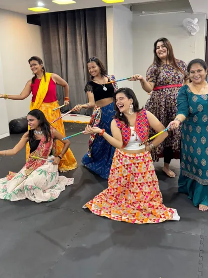 Posing with our dandiya sticks. These props add an extra layer of fun to our Navratri workouts.