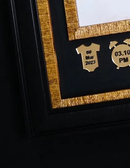It is all in the details. These small, golden charms record the baby's birth date and time, adding a very personal and informative element right into the artwork.