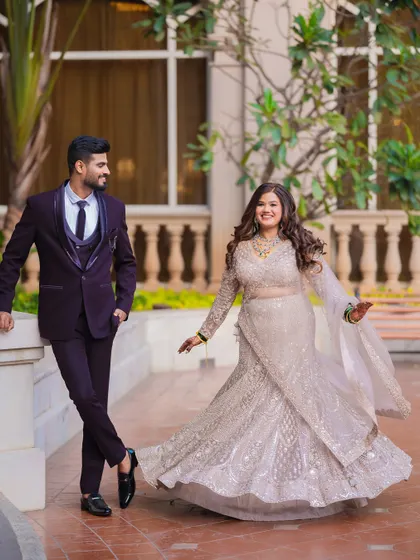 A beautiful full-length portrait of a couple at their reception, showcasing the bride's elegant gown.