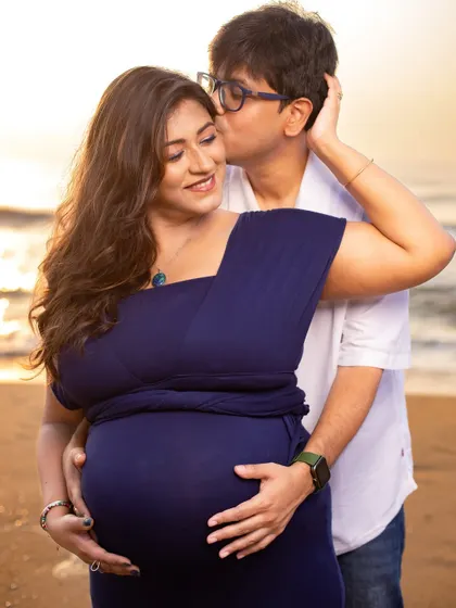 A sweet kiss for the glowing mom-to-be. These tender moments are what make a couple's maternity shoot so special and memorable.