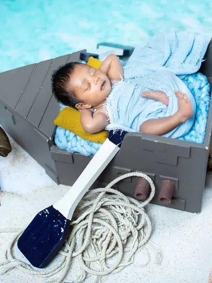 This little sailor is sleeping in his boat, surrounded by fishing nets and a vintage gramophone.