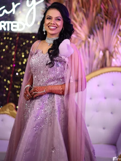 The best part of our job is seeing our happy clients. This beautiful client is glowing in one of our lavender reception gowns, complete with delicate embroidery and a stylish shoulder cape. Her smile says it all.