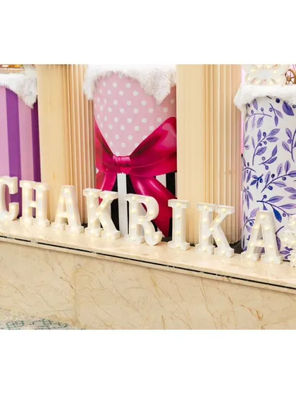 Personalized marquee letter's spelling out 'CHAKRIKA' add a special touch to the front of the stage.