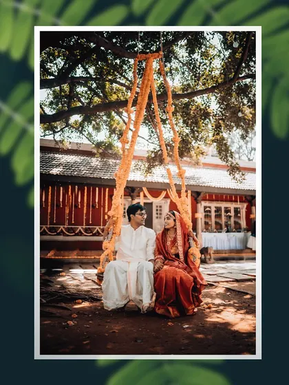 A peaceful moment of a bride and groom sitting on a traditional swing decorated with marigolds.