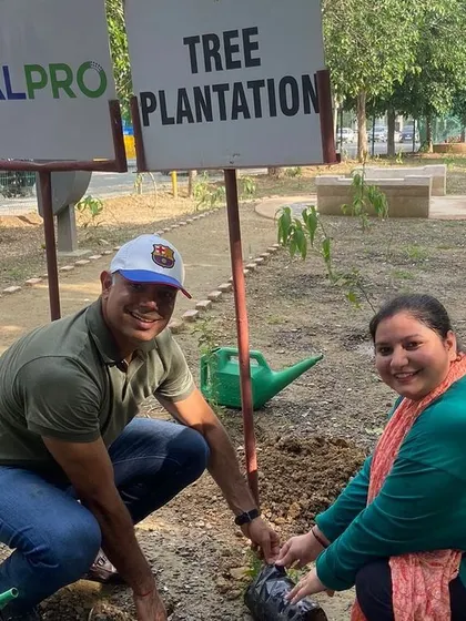 A couple from Calpro Specialties plants a native sapling together at Aravali Creek, a great example of how our corporate drives can be family-friendly events.
