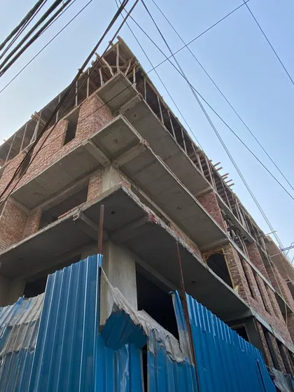 A corner view of the same New Delhi house, highlighting the building's angular form even in its unfinished state.