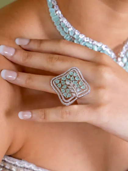 A beautiful statement ring with a tree-of-life design, from our mint-green diamond-look collection.