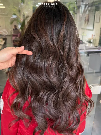 These waves don’t just move, they speak volume. A beautiful example of a rich brunette color with subtle dimension and a bouncy blowout.