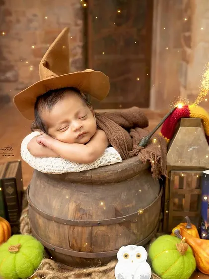 A smiling wizard. This precious shot captures a newborn smiling in his sleep during our magical Harry Potter themed session.