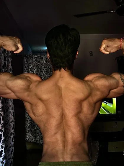 A final back double biceps pose, representing the culmination of the process of change.