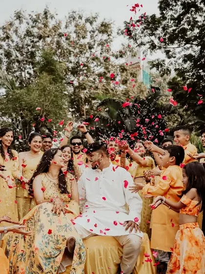 The beautiful chaos of a Haldi celebration, with flower petals flying everywhere. These action shots are always full of energy.