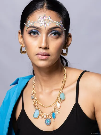 A portrait of a model wearing a layered necklace with natural stones and a crystal headpiece. This shows my work with bohemian and contemporary accessory brands.