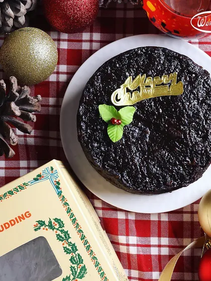 A top-down view of our classic Christmas Plum Pudding, ready to be the centrepiece of your holiday table. It's dense, moist, and full of the rich flavours of dried fruits and warm spices that define the festive season.