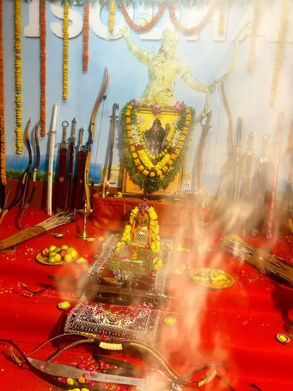 Smoke from the sacred fire rises before the altar during the puja. This ritual purifies the weapons and the space, consecrating them for the practice of this martial art.