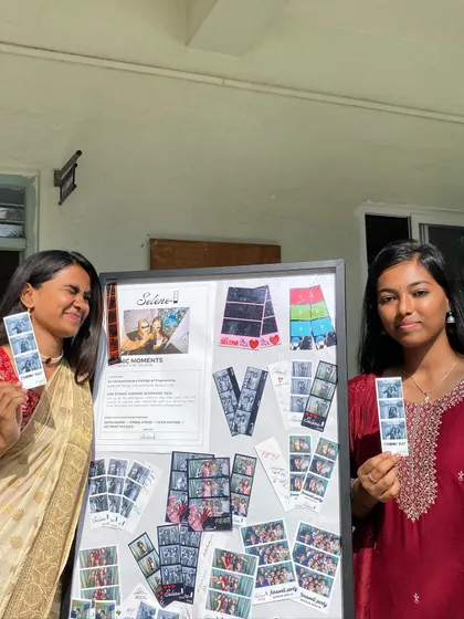Two students posing by the display board, showing off their prints from the SVCE ethnic day.