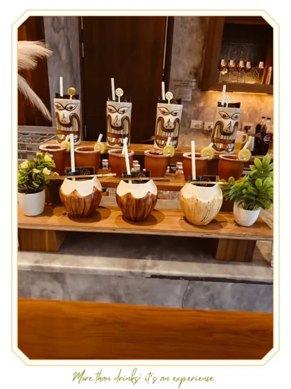 A vibrant Tiki bar setup, complete with traditional Tiki mugs and tropical garnishes. This concept is perfect for creating a fun, exotic, and laid-back party atmosphere.